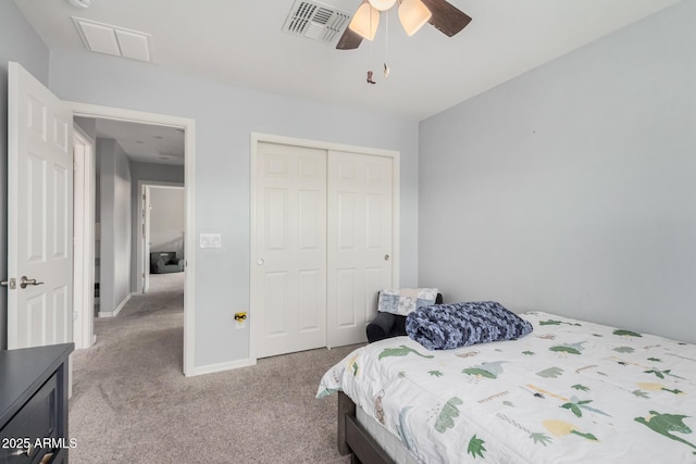 bedroom featuring ceiling fan, light carpet, and a closet