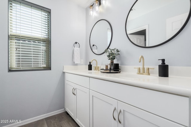 bathroom with hardwood / wood-style floors and vanity