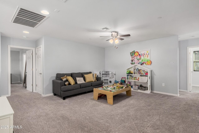 living room with ceiling fan and light colored carpet