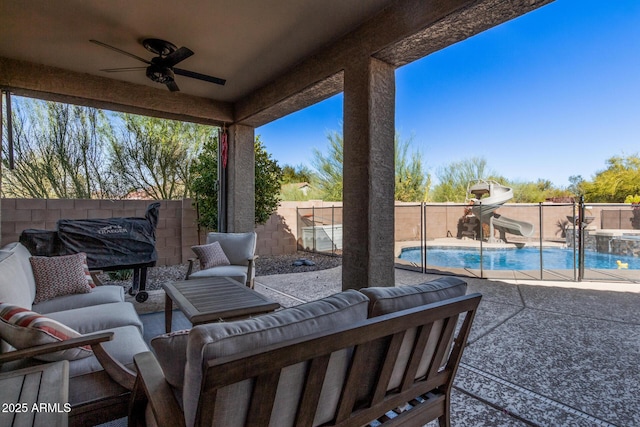 view of patio / terrace with a fenced in pool, ceiling fan, and an outdoor hangout area