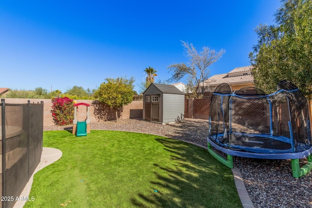 view of yard with a trampoline and a storage shed