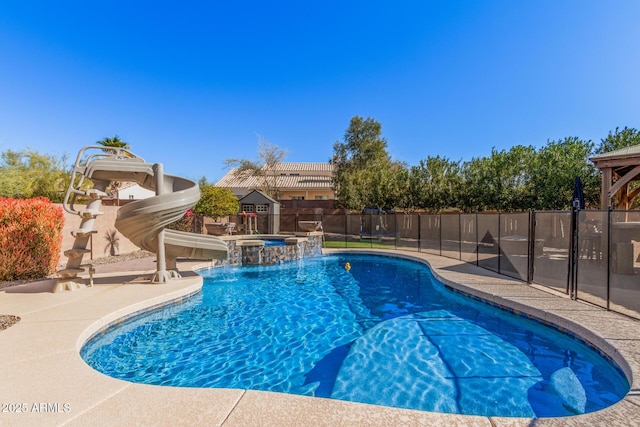 view of swimming pool with an in ground hot tub, a patio, pool water feature, and a water slide