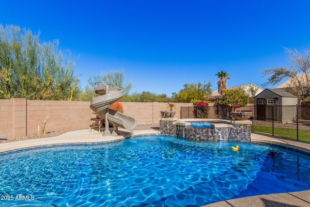 view of swimming pool featuring pool water feature, an in ground hot tub, and a water slide