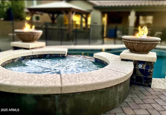 view of swimming pool with an in ground hot tub