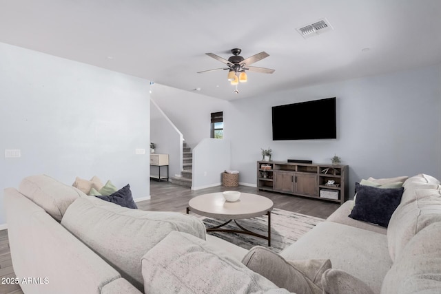 living room with ceiling fan and wood-type flooring