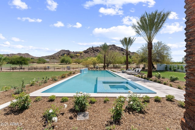 view of swimming pool featuring fence, a fenced in pool, a mountain view, a patio area, and a lawn