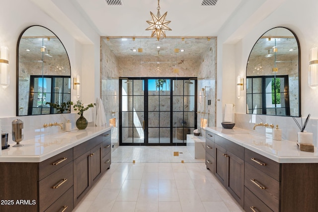 full bath with visible vents, a sink, two vanities, and tile patterned floors