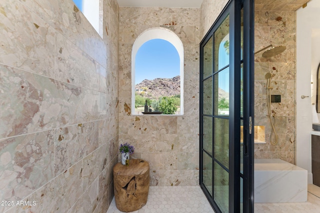 full bathroom with a bath and tiled shower