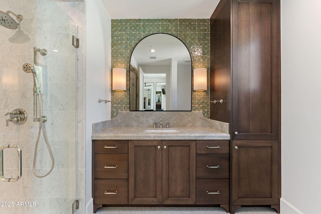 bathroom with visible vents, tile walls, tasteful backsplash, a shower stall, and vanity