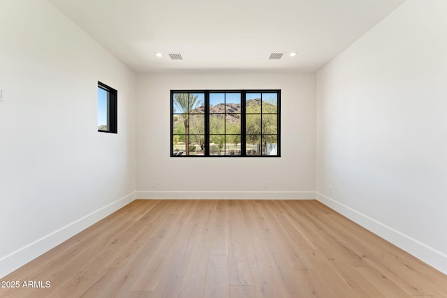empty room with recessed lighting, baseboards, visible vents, and light wood-type flooring