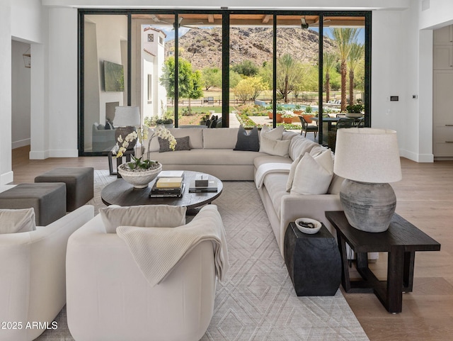 living room with baseboards and light wood-style flooring