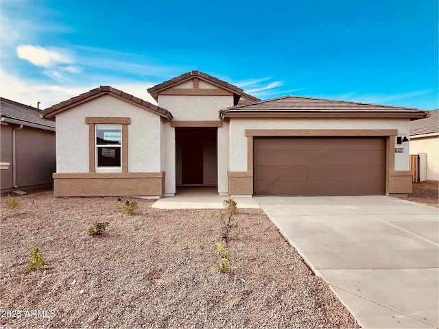 11948 E Aster Ln, Florence, AZ 85132 - view of front facade featuring concrete driveway, a garage, stucco siding, and a tiled roof