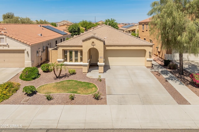 9852 W Salter Dr, Peoria, AZ 85382 - view of front of house featuring a garage, driveway, stucco siding, and a tile roof