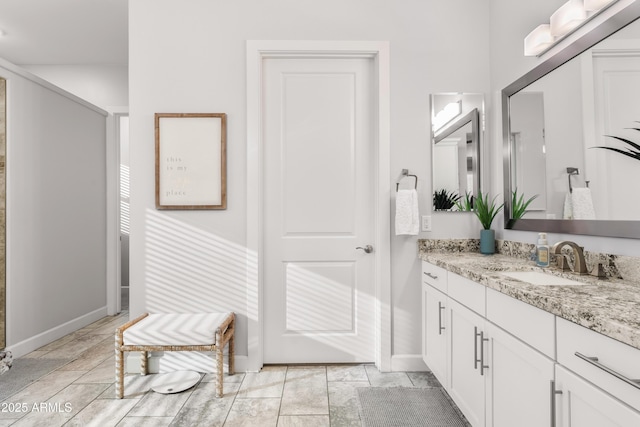 bathroom featuring vanity and baseboards