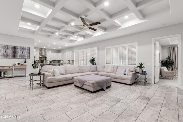 living room featuring a ceiling fan, coffered ceiling, beamed ceiling, and recessed lighting