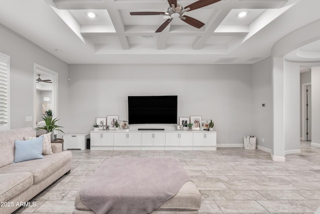 living area featuring ceiling fan, baseboards, coffered ceiling, and beam ceiling