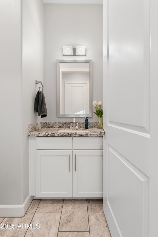 bathroom featuring vanity and baseboards