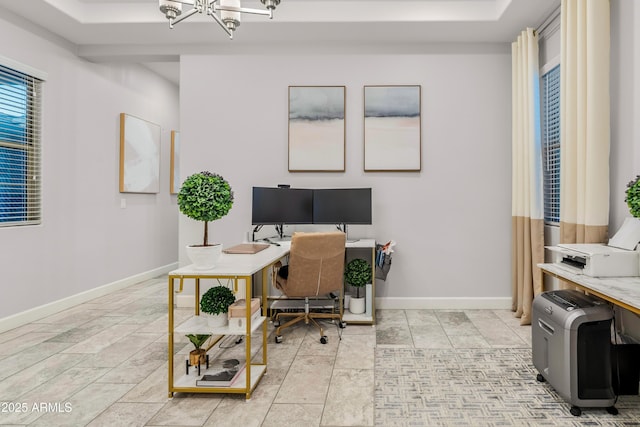 office space featuring baseboards and a notable chandelier