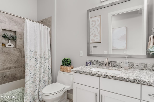 bathroom featuring toilet and vanity