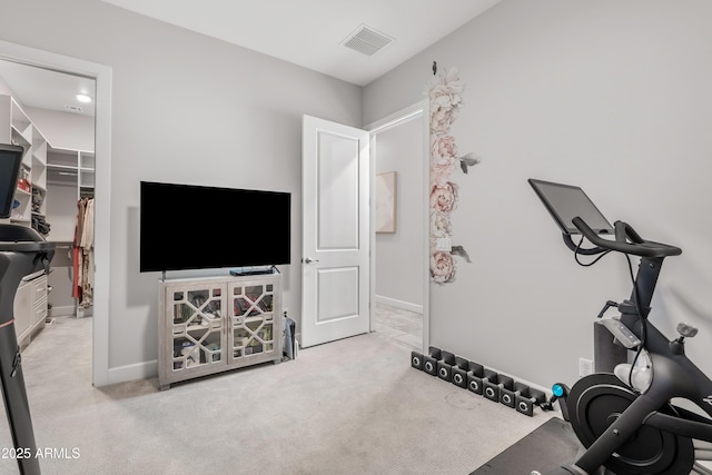 workout area with baseboards, visible vents, and light colored carpet