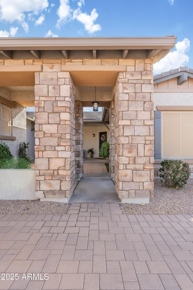 view of exterior entry featuring stone siding