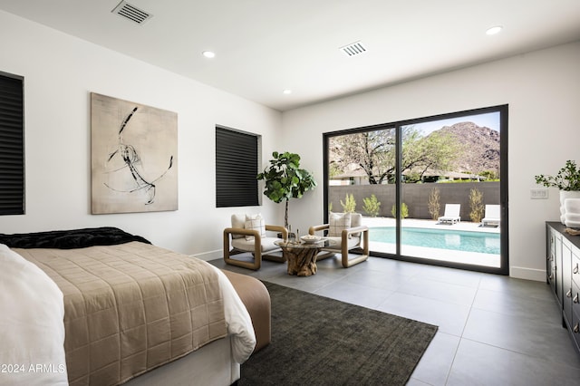 bedroom with light tile patterned floors and access to outside