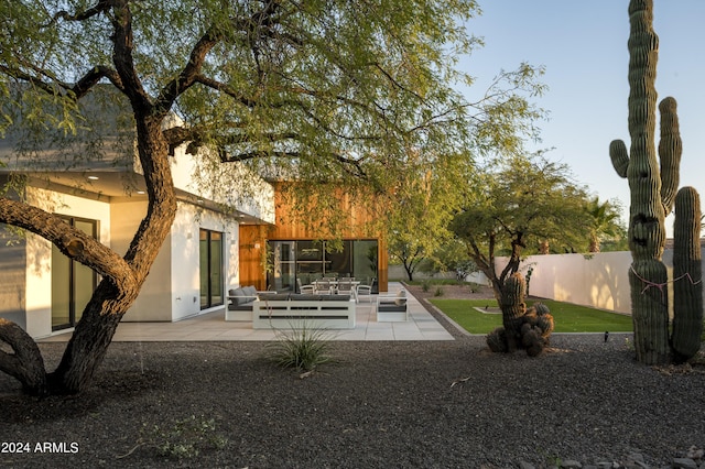 view of home's community featuring an outdoor living space and a patio