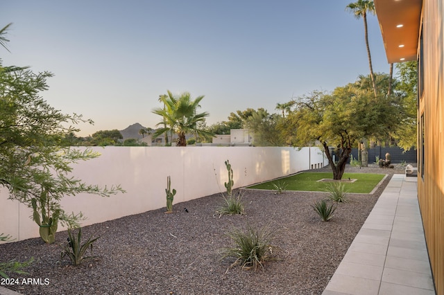 yard at dusk featuring a mountain view