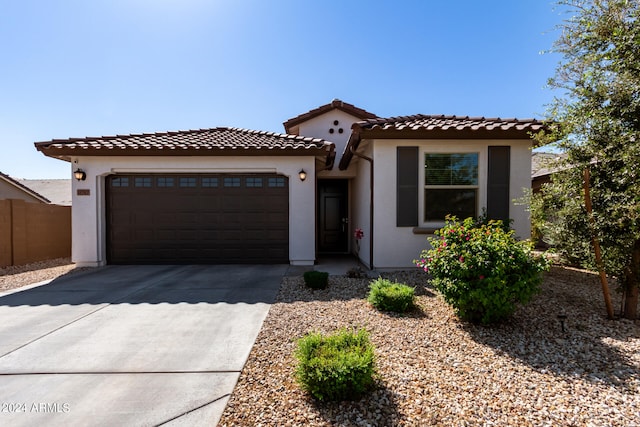 mediterranean / spanish-style home with a garage