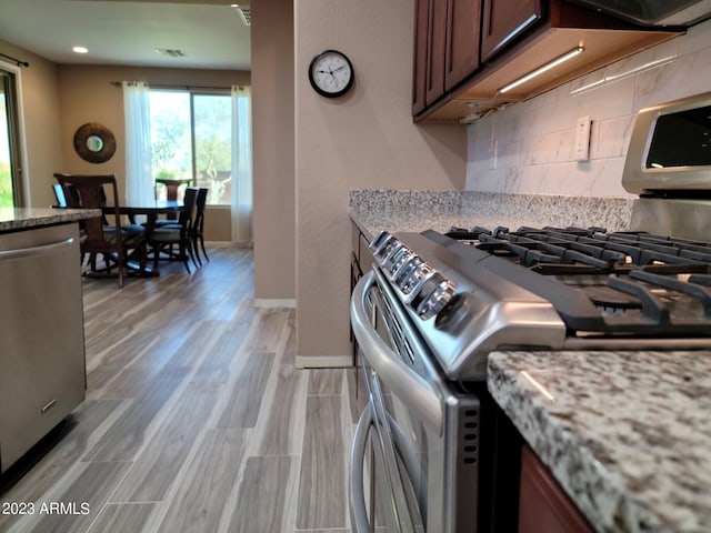 kitchen featuring appliances with stainless steel finishes and tasteful backsplash