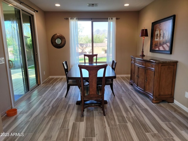 dining space with hardwood / wood-style flooring