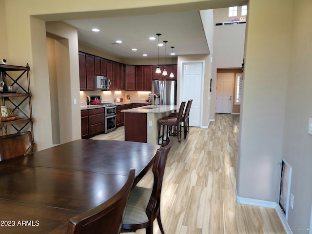 dining room featuring sink and light hardwood / wood-style flooring