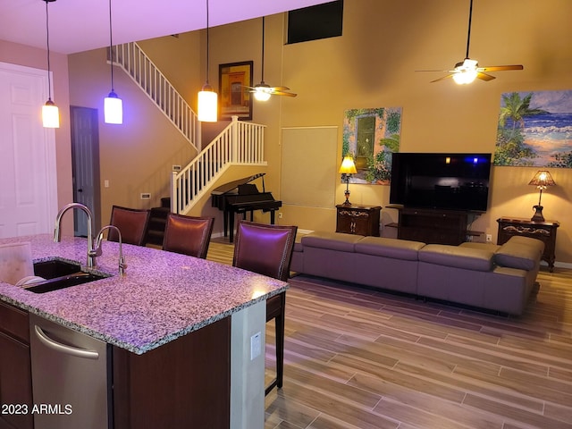 kitchen with hardwood / wood-style floors, sink, ceiling fan, and pendant lighting