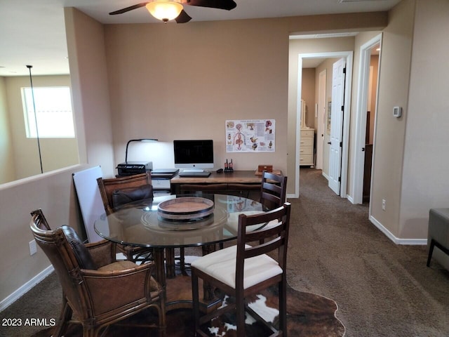 carpeted dining space featuring ceiling fan