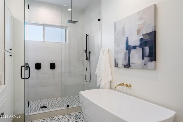 bathroom with tile patterned flooring and separate shower and tub