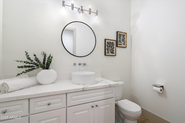 bathroom featuring toilet and vanity