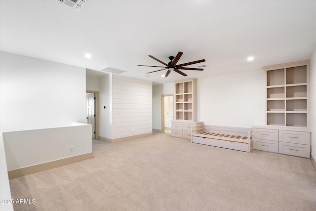 unfurnished living room with ceiling fan and light carpet