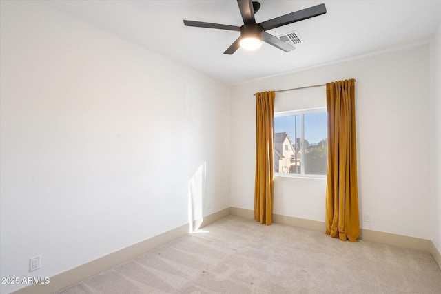 spare room with light colored carpet and ceiling fan