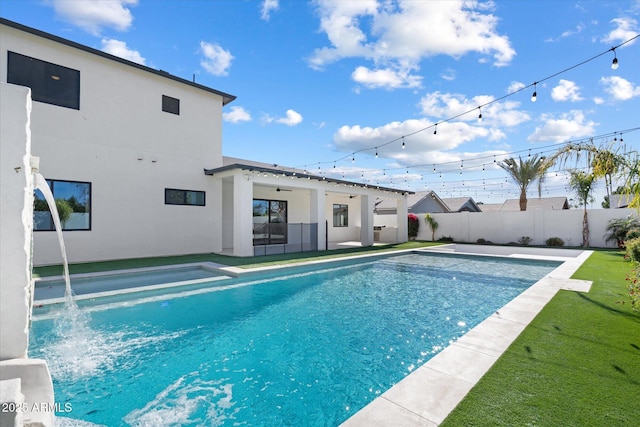 view of swimming pool with pool water feature and a patio area