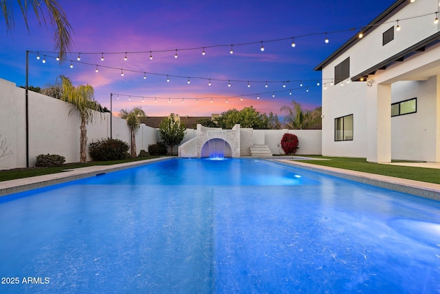 view of pool at dusk