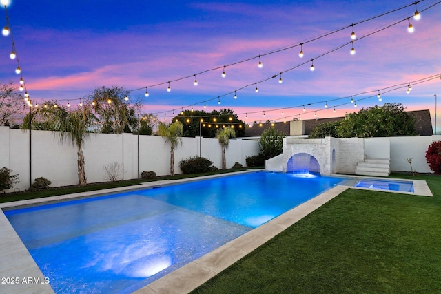 pool at dusk with a lawn