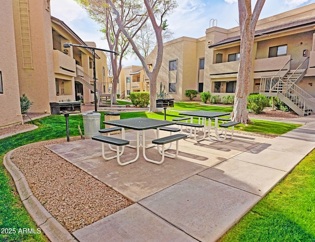 surrounding community featuring a patio, a lawn, and a residential view