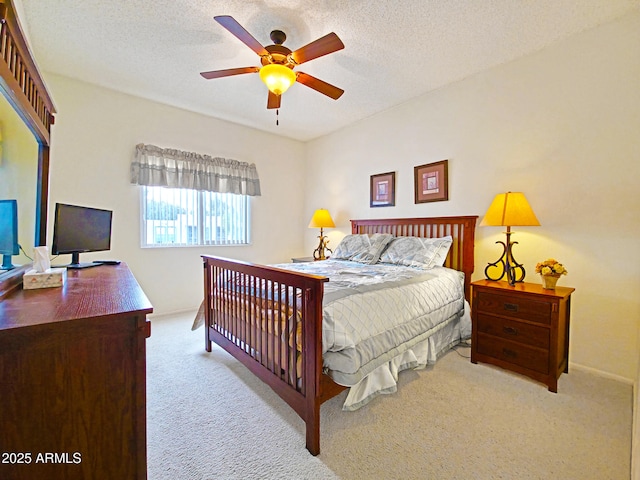 carpeted bedroom featuring ceiling fan, a textured ceiling, and baseboards