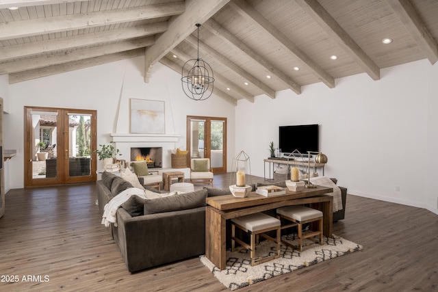 living area with french doors, a large fireplace, high vaulted ceiling, and wood finished floors