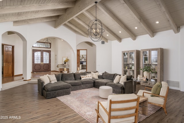 living room featuring visible vents, a notable chandelier, high vaulted ceiling, wood finished floors, and wood ceiling