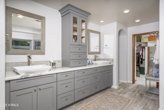 bathroom featuring double vanity, recessed lighting, visible vents, and a sink