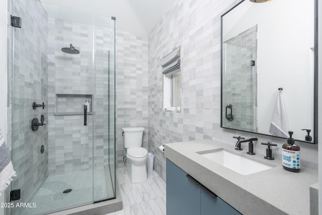 full bathroom with toilet, tile walls, a shower stall, tile patterned flooring, and vanity