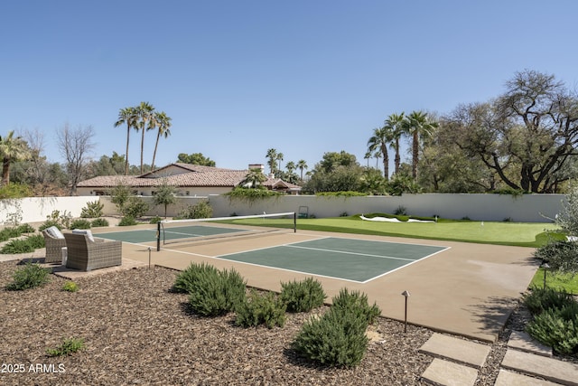 view of sport court featuring fence