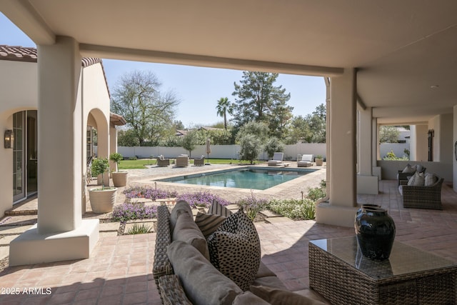 view of patio featuring outdoor lounge area, a fenced backyard, and a fenced in pool