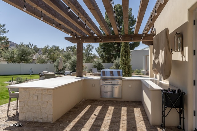 view of patio / terrace featuring grilling area, a pergola, exterior kitchen, and a fenced backyard